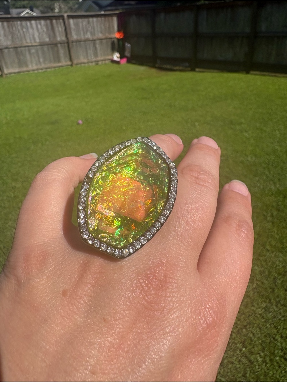 Blue/Green iridescent stone with pewter metal and clear stones all around size 7